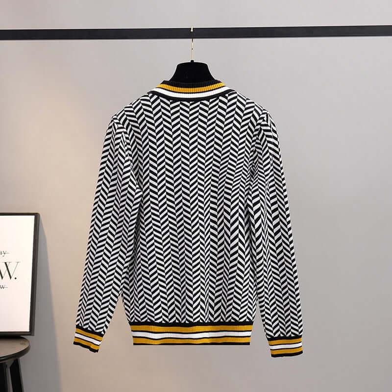 Back view of women's knitted sweaters featuring herringbone pattern and yellow accents.
